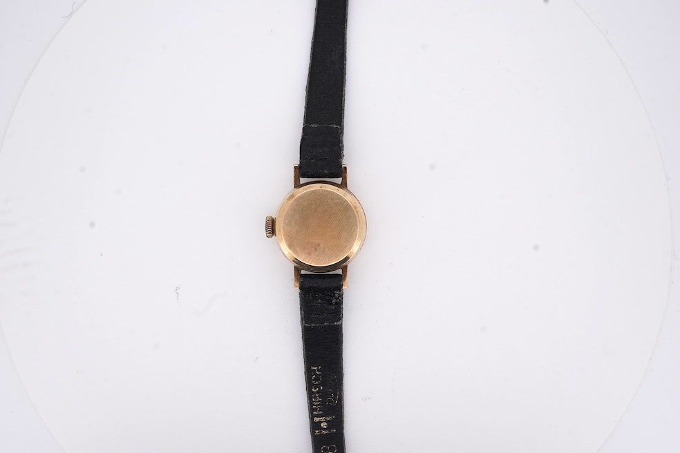 A lady's 9ct gold Omega Automatic wrist watch, on an associated leather strap, gross weight 11 grams. Condition - poor to fair